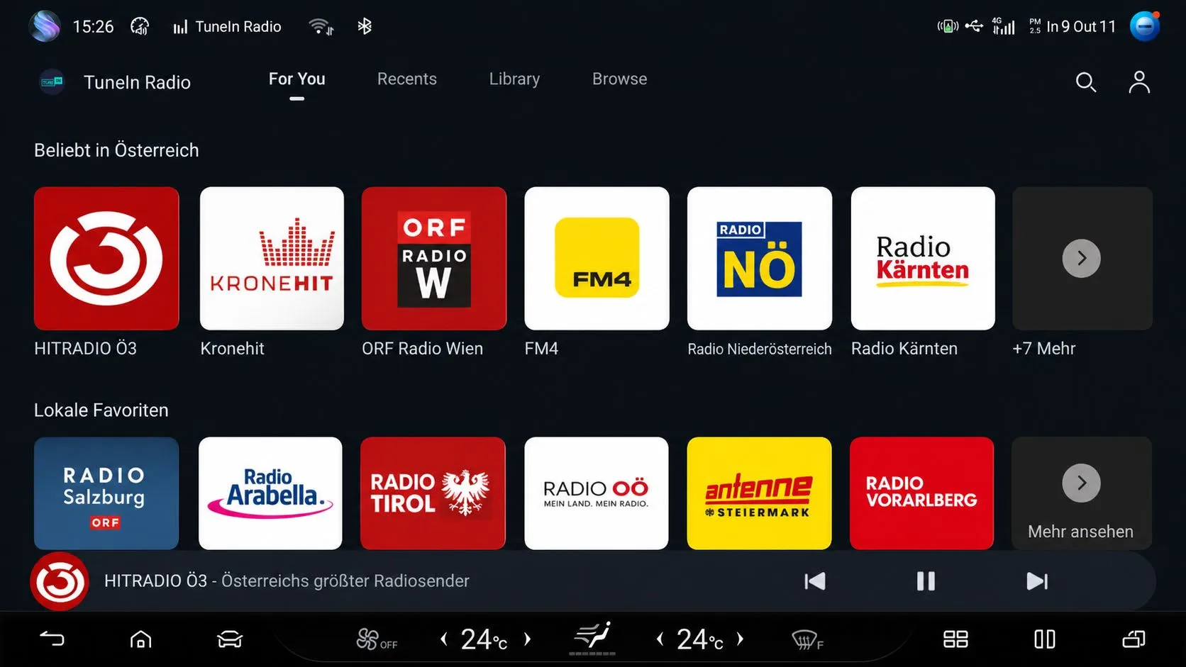 Head-unit screenshot of the TuneIn Radio app showing the For You tab with rows ‘Beliebt in Österreich’ (HITRADIO Ö3, Kronehit, ORF Radio Wien, FM4, Radio Niederösterreich, Radio Kärnten) and ‘Lokale Favoriten’ (Radio Salzburg, Radio Arabella, Radio Tirol, Radio OÖ, Antenne Steiermark, Radio Vorarlberg), with HITRADIO Ö3 playing in the bottom bar.