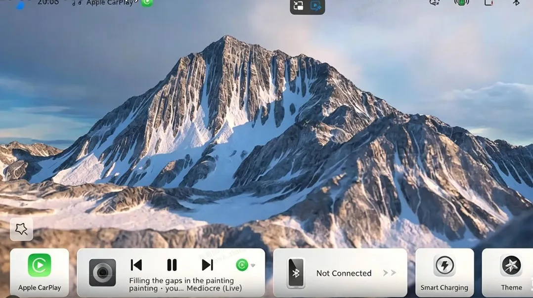 Head-unit home screen with a mountain wallpaper and a widget row along the bottom: an Apple CarPlay tile, a media card with transport controls and the currently playing track, a Bluetooth phone card reading “Not Connected”, Smart Charging and Theme; the status bar shows Apple CarPlay as the active source.