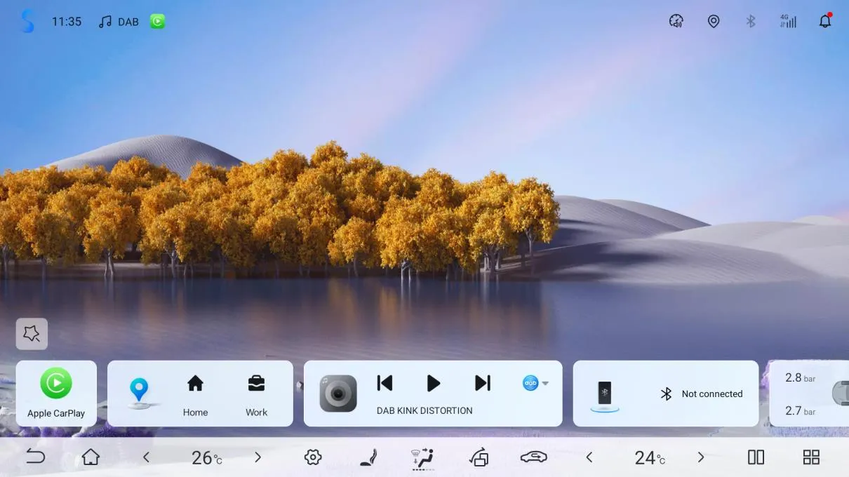 Head-unit home screen in the new UI: landscape wallpaper, and a bottom widget row with an Apple CarPlay shortcut, navigation shortcuts (Home, Work), a media widget playing DAB KINK DISTORTION, a Bluetooth widget showing Not connected, and a tyre pressure card reading 2.8 bar and 2.7 bar.