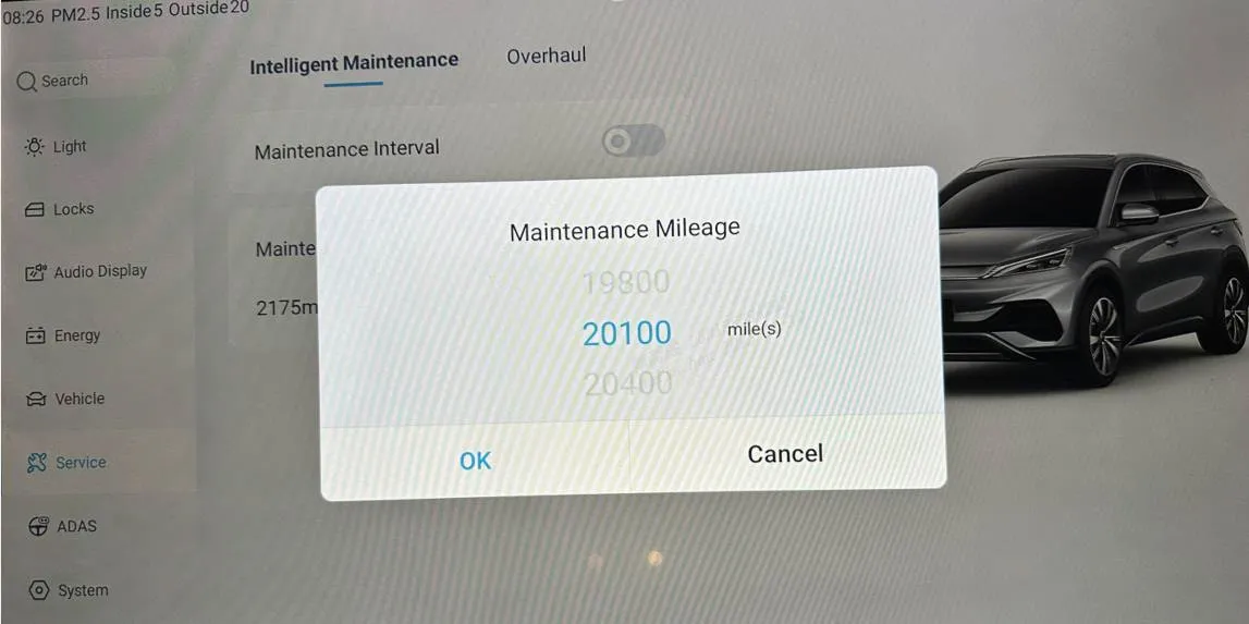 Photograph of the head-unit screen in Service, Intelligent Maintenance tab, with a Maintenance Mileage picker dialogue set to 20100 mile(s) between 19800 and 20400, and OK and Cancel buttons.