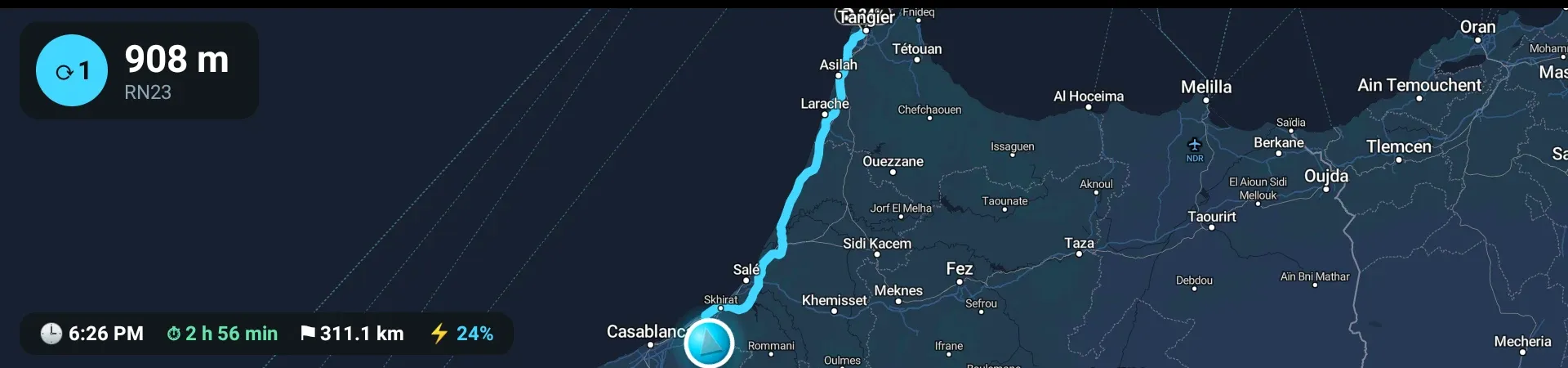 The instrument cluster showing a roundabout card reading 908 m, RN23 with an exit number, the planned route drawn the length of the country, and a bar reading 6:26 PM, 2 hours 56 minutes, 311.1 km and 24 percent